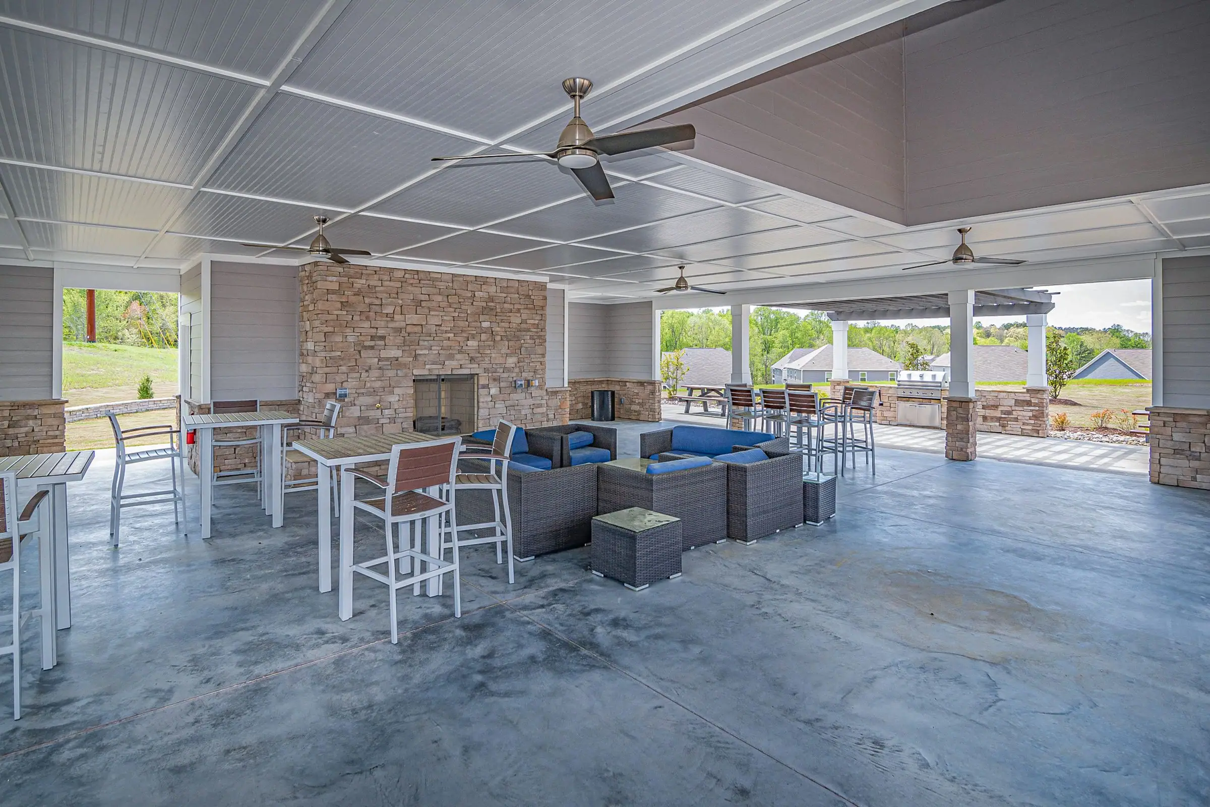 Large solid patio cover with ceiling fans over lounge and dining areas