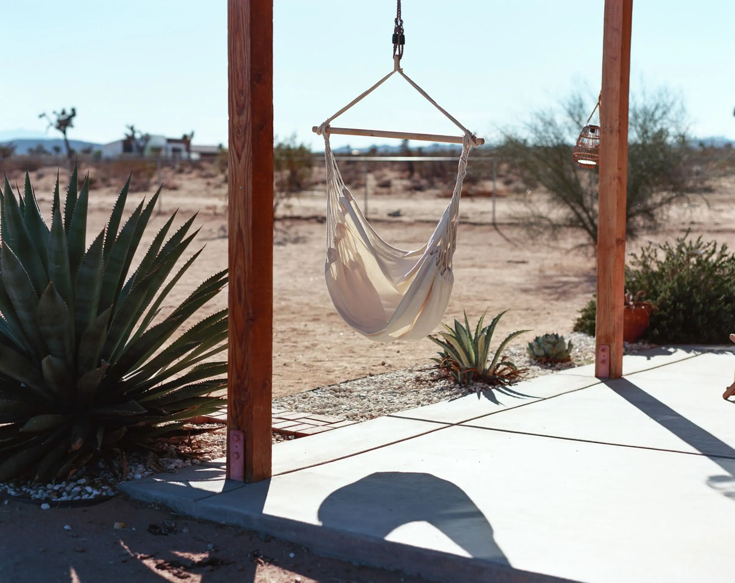 Wood posts with a hanging hammock looking out over desert ground